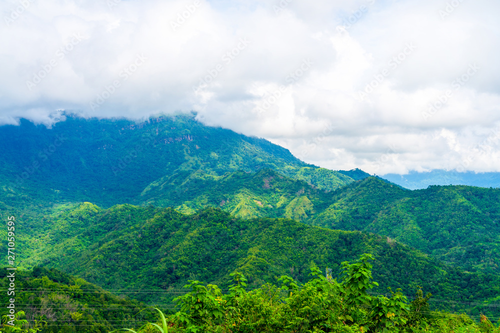 Obraz premium Blue sky high peak mountains fog hills mist scenery national park views at Phu Tub Berk, Khao Koh, Phetchabun Province, Thailand