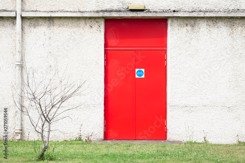 Fire exit red door and white wall at work place © Richard Johnson