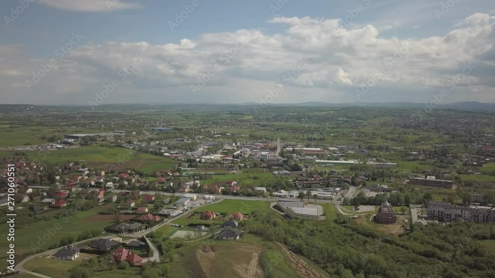 Panorama from a bird's eye view. Central Europe: town or village is located among the green hills. Temperate climate. Flight drones or quadrocopter on the industrial area. Near Jaslo town of Polish Panorama from a bird's eye view. Central Europe: town or village is located among the green hills. Temperate climate. Flight drones or quadrocopter on the industrial area. Near Jaslo town of Polish