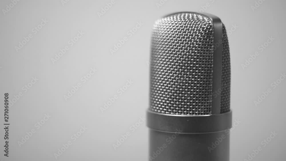 Closeup Of A Condenser Microphone With Lighting Changing In Background. Closeup Of A Condenser Microphone With Lighting Changing In Background.
