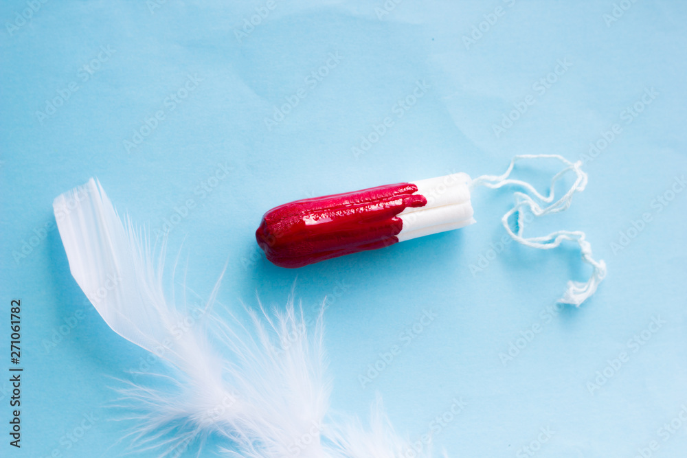 The concept of critical days, menstruation. Isolated tampons on a colored  background, close-up. Ease on