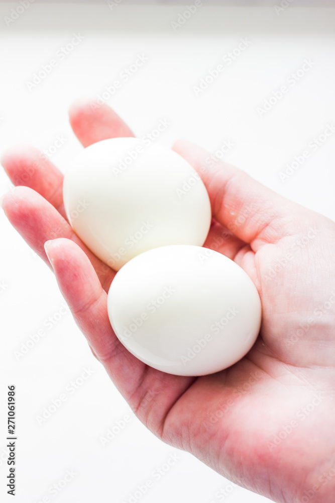 Eggs in hand isolated on white background. Egg close up on a white background. White chicken eggs on a white background.
