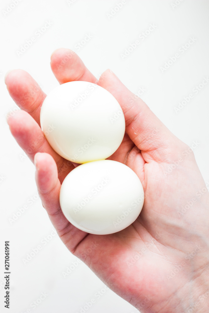Eggs in hand isolated on white background. Egg close up on a white background. White chicken eggs on a white background.