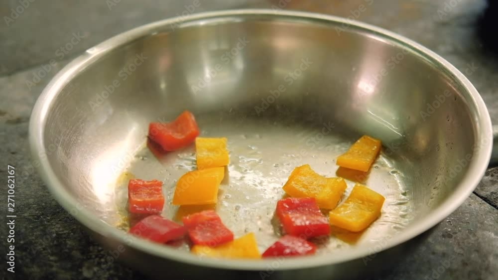 Meal preparing. Food cooking process. Sliced bell pepper thrown in frying pan Meal preparing. Food cooking process. Sliced bell pepper thrown in frying pan