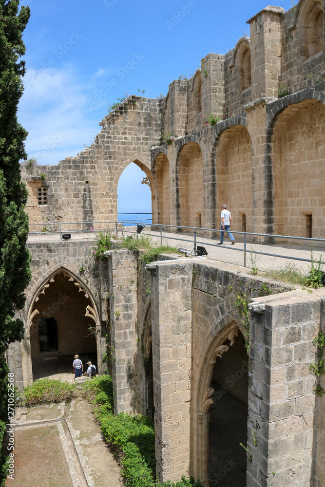 tourists visiting Bellapais Abbey ruins  in turkish Cyprus