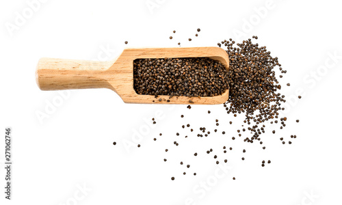 sesame seeds in wood scoop isolated on white background