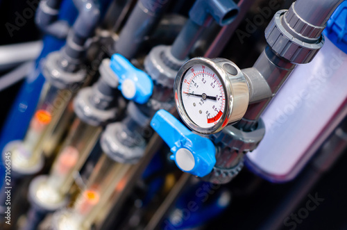 Close up of house heating system with many steel pipes, manometers and metal tubes.