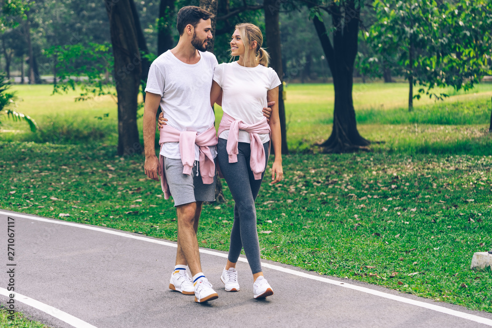 Lover couples smiling happy face holding and walking in the Park Lover couples smiling happy face holding and walking in the Park