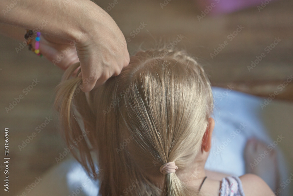 Fototapeta premium woman hand children girl hairstyle 