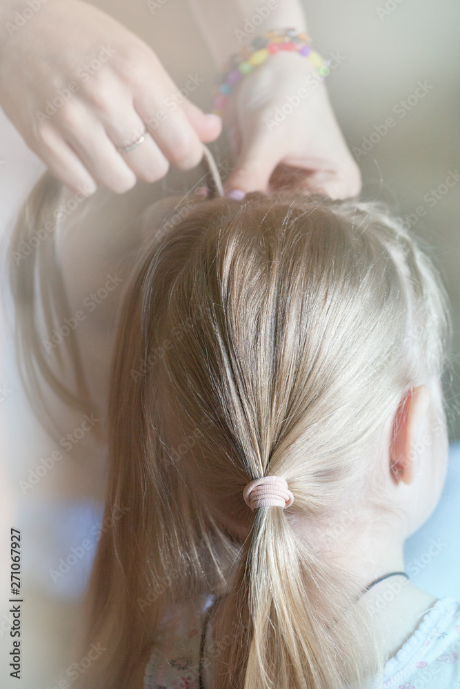 Fototapeta premium woman hand children girl hairstyle 