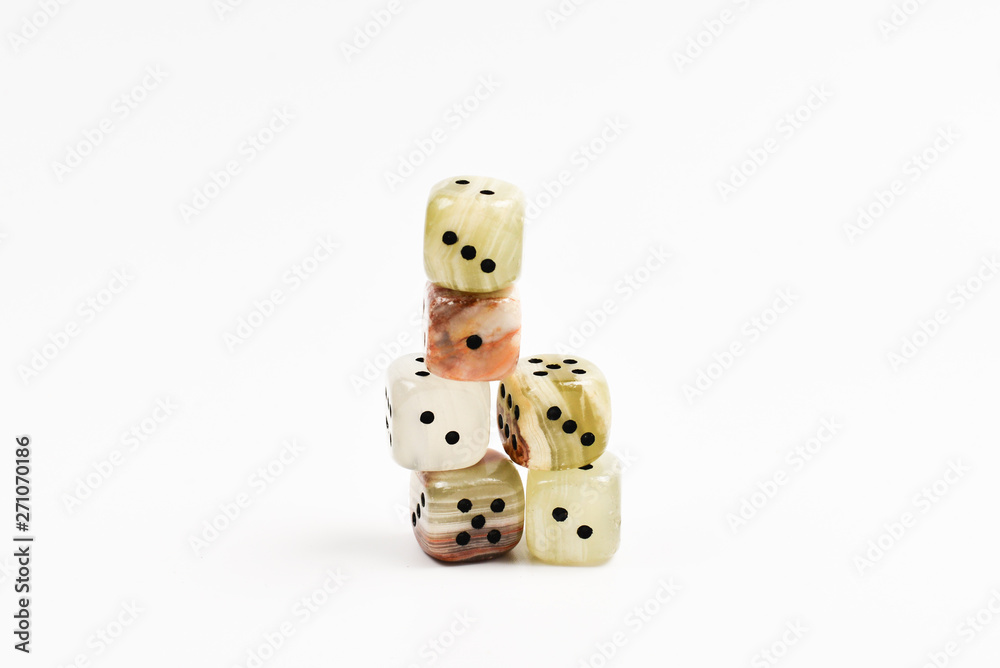 Dices made of natural stone on a white background. Copy space. Gaming. Dices made of natural stone on a white background. Copy space. Gaming.