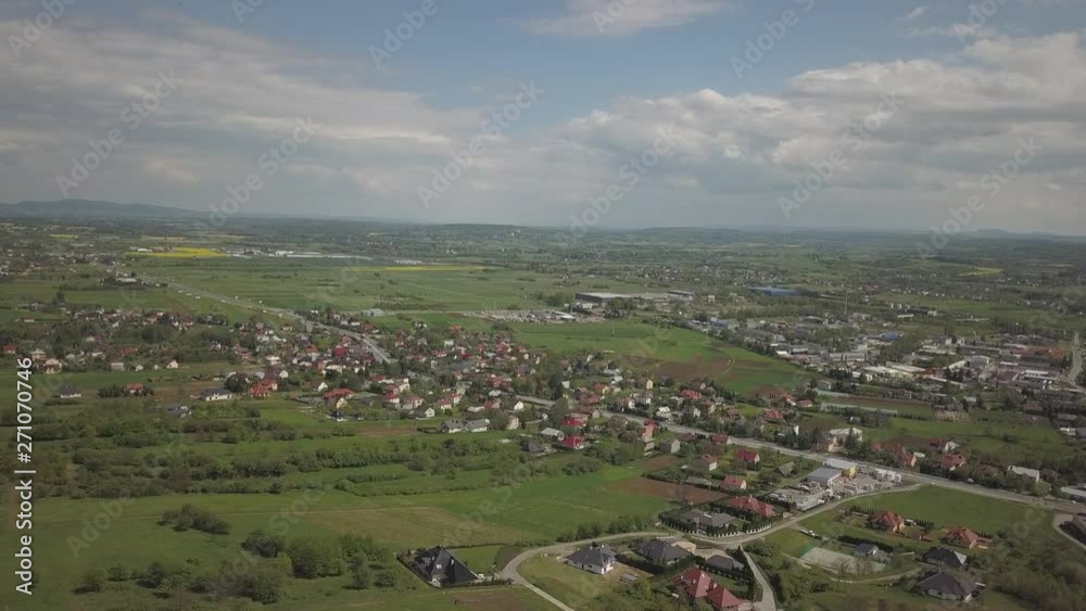 Panorama from a bird's eye view. Central Europe: town or village is located among the green hills. Temperate climate. Flight drones or quadrocopter on the industrial area. Near Jaslo town of Polish Panorama from a bird's eye view. Central Europe: town or village is located among the green hills. Temperate climate. Flight drones or quadrocopter on the industrial area. Near Jaslo town of Polish