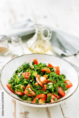 Healthy tomato salad with cucmbers, dill, onion and parsley