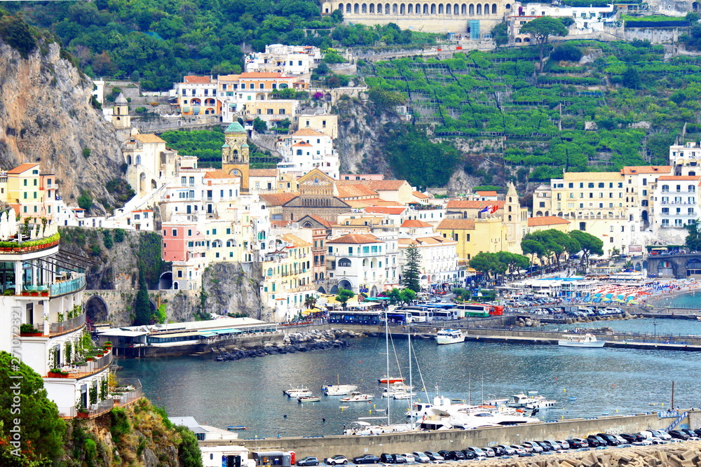 Fototapeta premium Panoramic scenic view of Amalfi Coast, Campania, Italy, in summer with traditional Italian architecture on mountains, beautiful blue sea and luxury yachts