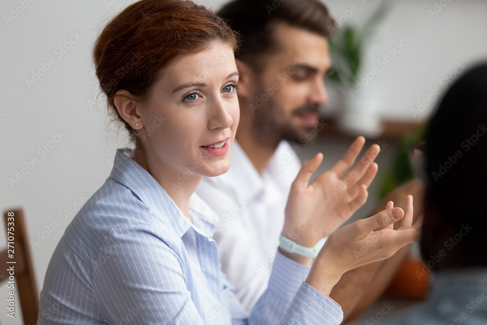 Close up attractive businesswoman sitting and talking to colleague Close up attractive businesswoman sitting and talking to colleague