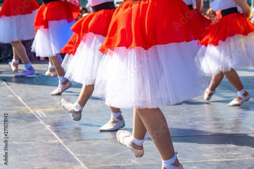 legs of dancing girls in red dresses