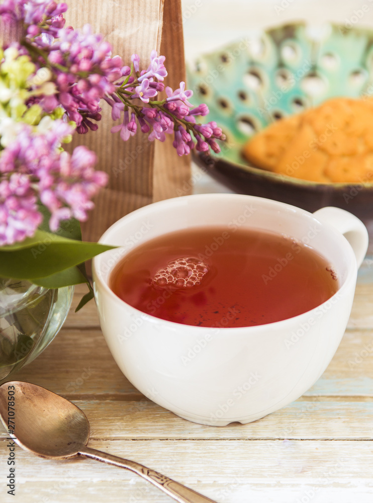 Tea and blooming lilac, petal in a cup Tea and blooming lilac, petal in a cup