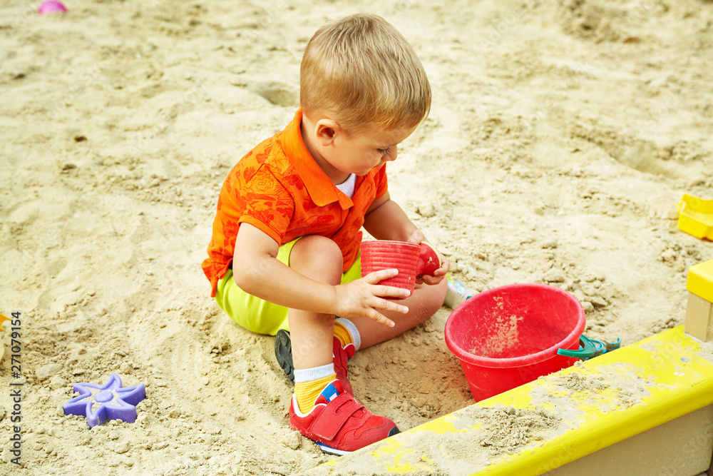 little boy on playground. playing child in sandbox little boy on playground. playing child in sandbox