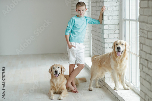 A boy with a dog at home.