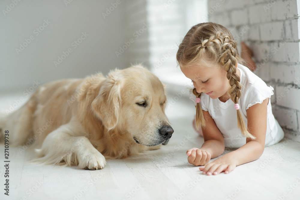A child with a dog at home. 
