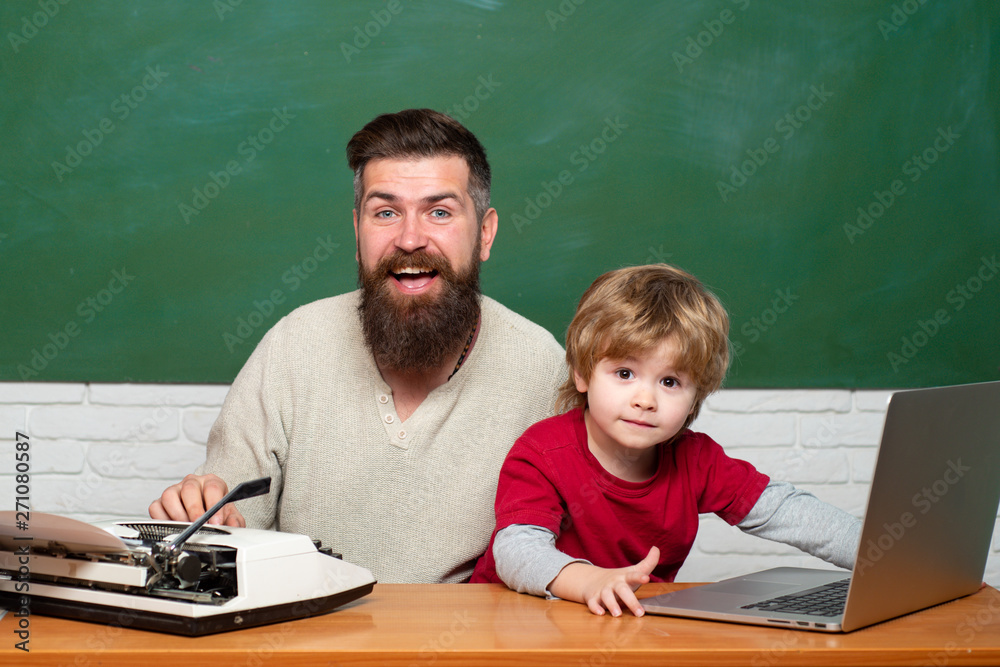 Teacher helping kids with their homework in classroom at school. Back to school. Parent Teacher. Man teaches child. First day in school. Young adult concept. Father and son. Teacher helping kids with their homework in classroom at school. Back to school. Parent Teacher. Man teaches child. First day in school. Young adult concept. Father and son.
