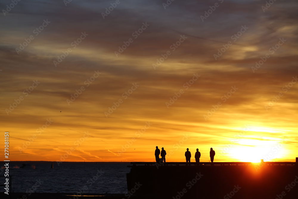 silhouettes of a group of people on the beach
