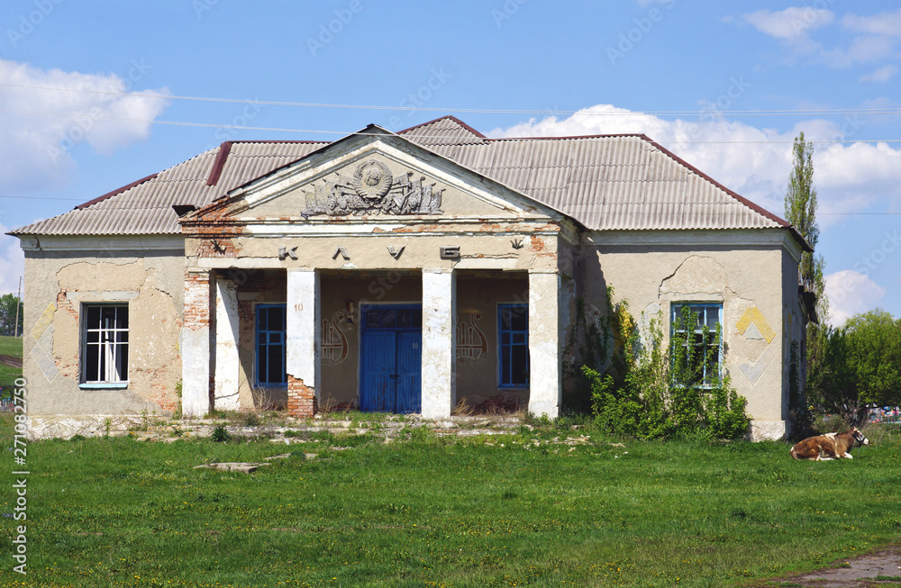 Crumbling cultural building in small village in Voronezh region, Russia. Sign 'club' is on facade of building Crumbling cultural building in small village in Voronezh region, Russia. Sign 'club' is on facade of building