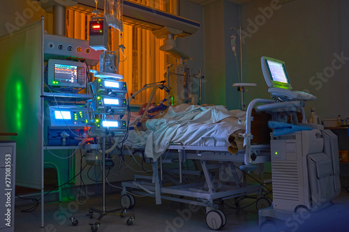 Glowing monitors in intensive care department. Nigth shift at icu, patient in critical state.