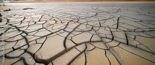 Foto Dried land in the desert. Cracked soil crust