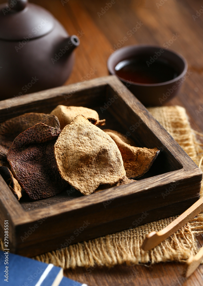 chinese dried tangerine peel in wooden box with tea chinese dried tangerine peel in wooden box with tea