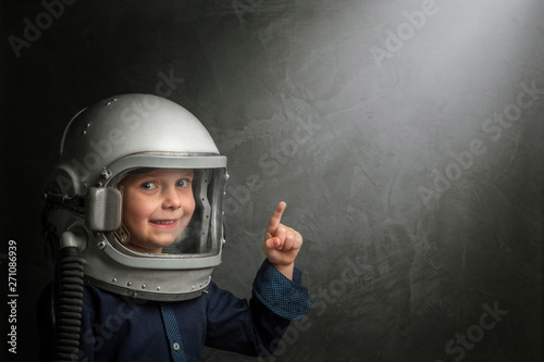 Small child wants to fly an airplane wearing an airplane helmet