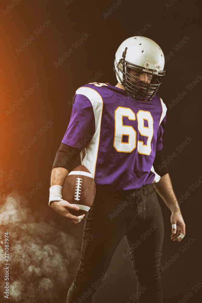 Portrait close-up, American football player, bearded without a helmet with the ball in his hands. Concept American football, patriotism, close-up.
