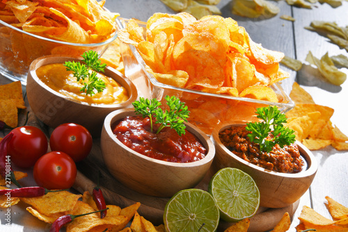 Composition with bowl of potato chips. photo