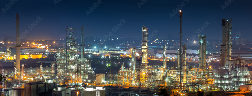 Oil refinery industry for distillate crude oil to gasoline for energy business and transportation and environmental concept, after sunset time and industrial zone in background