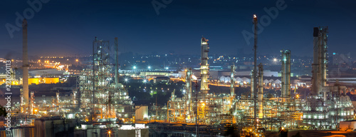 Oil refinery industry for distillate crude oil to gasoline for energy business and transportation and environmental concept, after sunset time and industrial zone in background