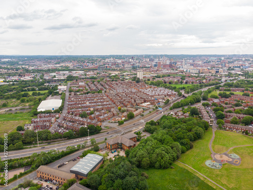 Aerial photo over looking the whole of Leeds from the Beeston area of the City Centre in West Yorkshire, the photo shows rows of 1940's terrace houses and playing fields. © Duncan