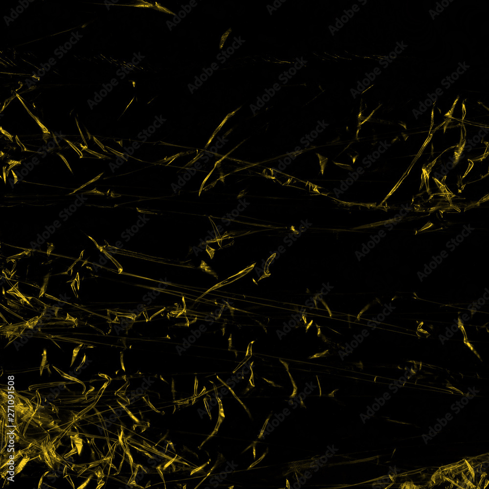 Transparent yellow plastic wrap on the black background. Plastic shopping bag texture. Reusable trash and waste. Transparent yellow plastic wrap on the black background. Plastic shopping bag texture. Reusable trash and waste.