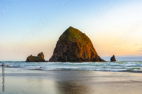 Beautiful Haystack Rock, famous natural landmark of the Pacific Coast, at sunset, Cannon Beach, Oregon Coast, USA.