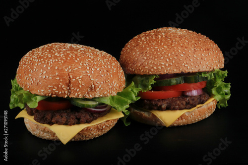 two hamburger on black background
