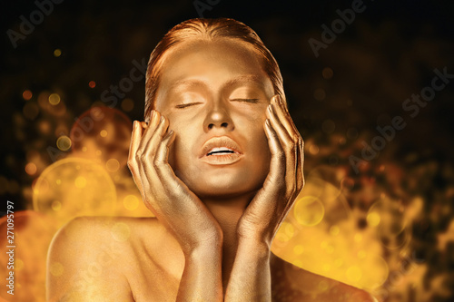 Obraz na plátně Portrait of beautiful lady with gold paint on skin against blurred lights