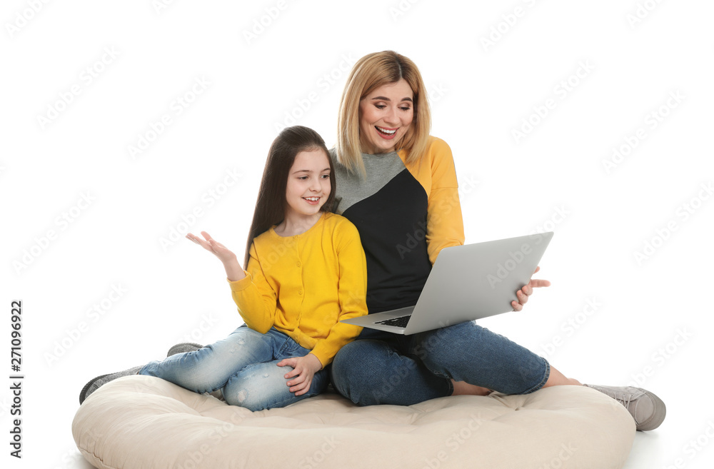 Mother and her daughter using video chat on laptop against white background Mother and her daughter using video chat on laptop against white background