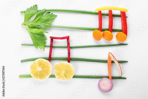 Fototapeta Naklejka Na Ścianę i Meble -  Musical notes made of vegetables and fruits on white background, top view