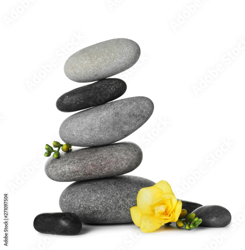 Canvas Print Stack of spa stones and beautiful flower on white background
