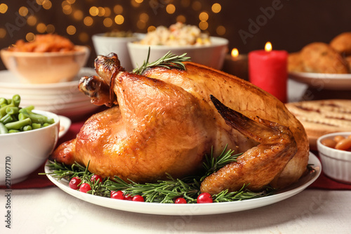 Traditional festive dinner with delicious roasted turkey served on table photo