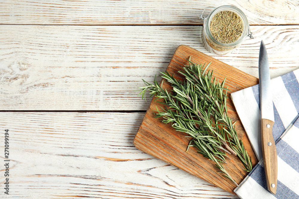 Flat lay composition with fresh rosemary twigs on wooden table. Space for text Flat lay composition with fresh rosemary twigs on wooden table. Space for text