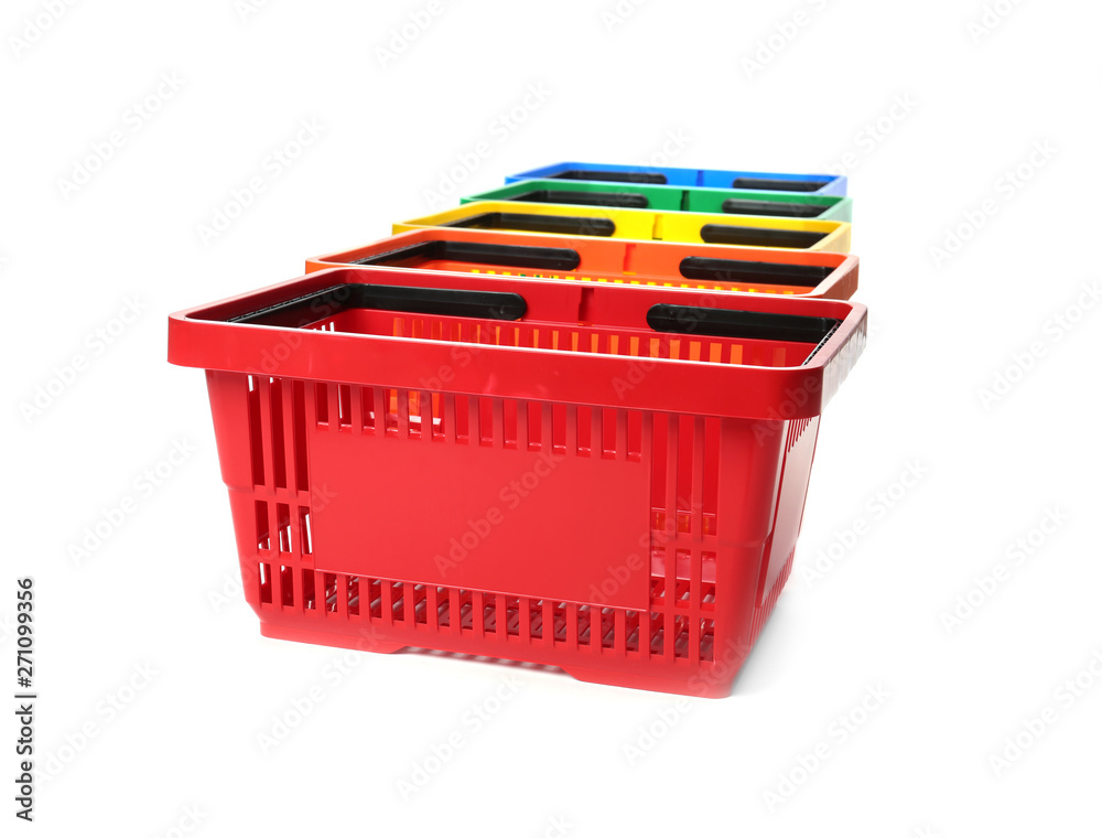 Fototapeta premium Colorful plastic shopping baskets on white background