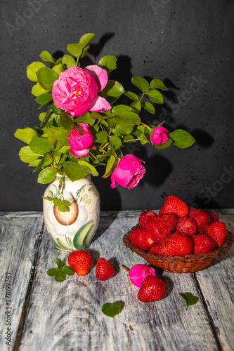 bouquet of red roses and heart on wooden background