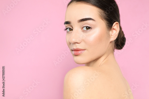 Portrait of young woman with beautiful face against color background. Space for text