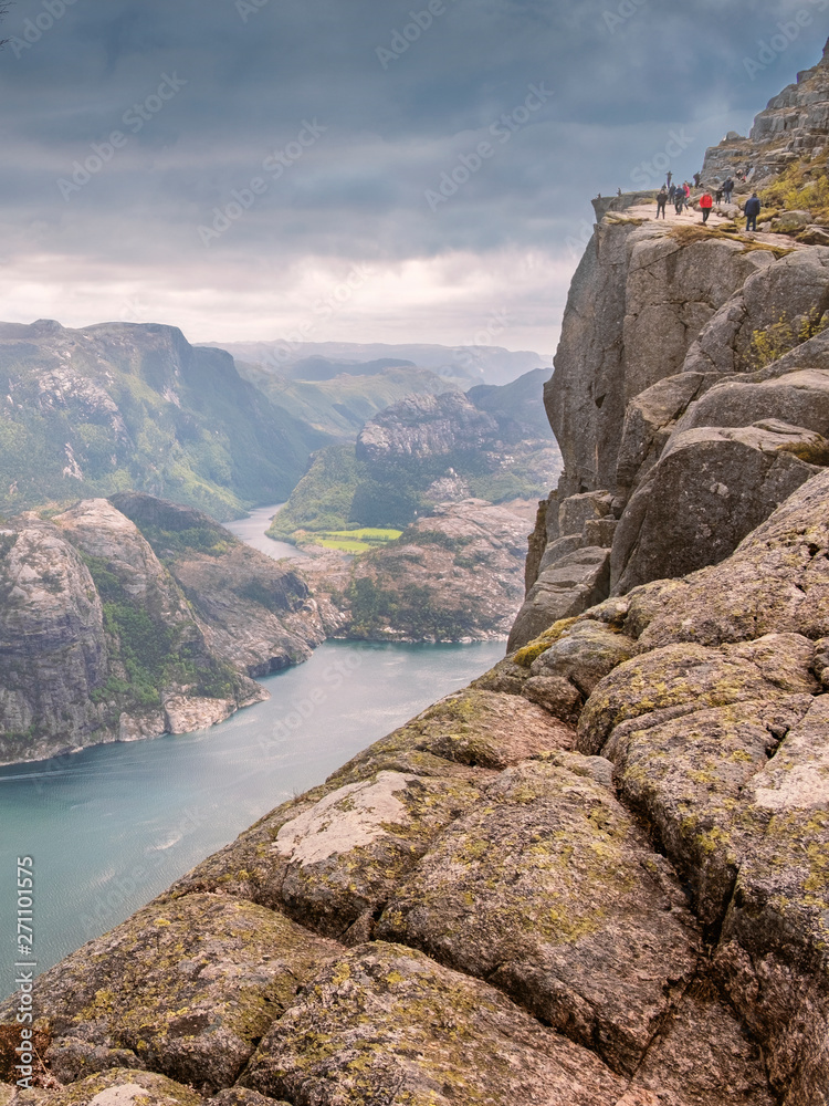 Tourists walk along a steep mountain path to the Rockpreikestolen over  lysefjord in Norway Stock Photo | Adobe Stock
