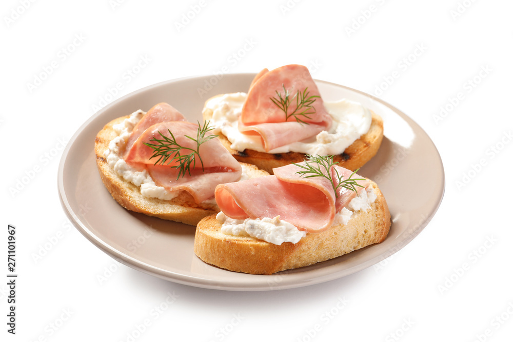 Plate of tasty bruschettas with ham on white background